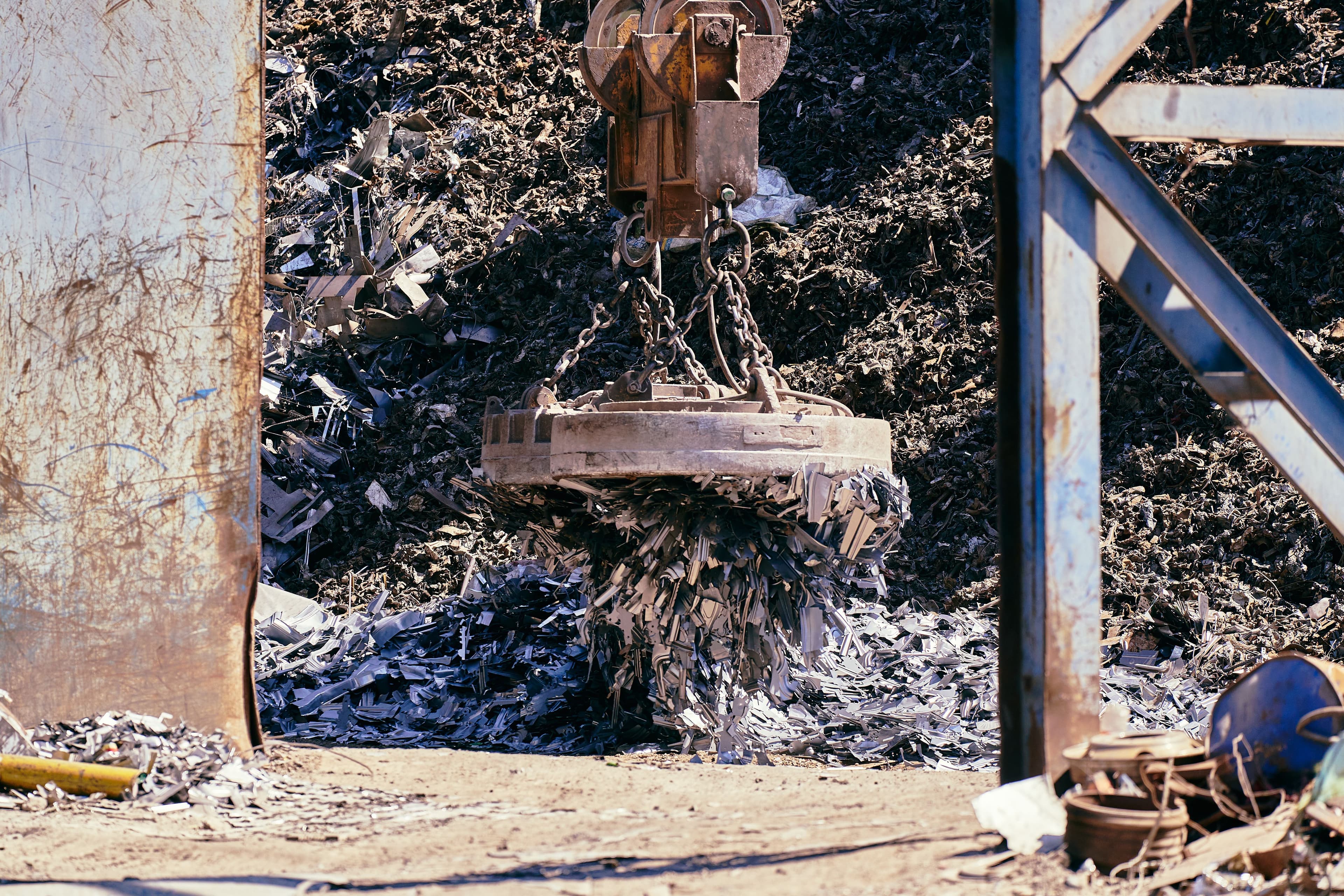 Lifting magnet handling metal scrap at an industrial yard
